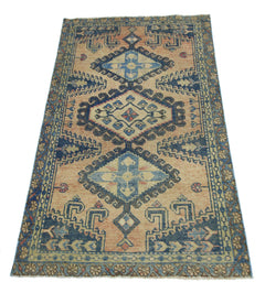A vintage Persian Wiss rug featuring a geometric diamond pattern in blue and tan tones.