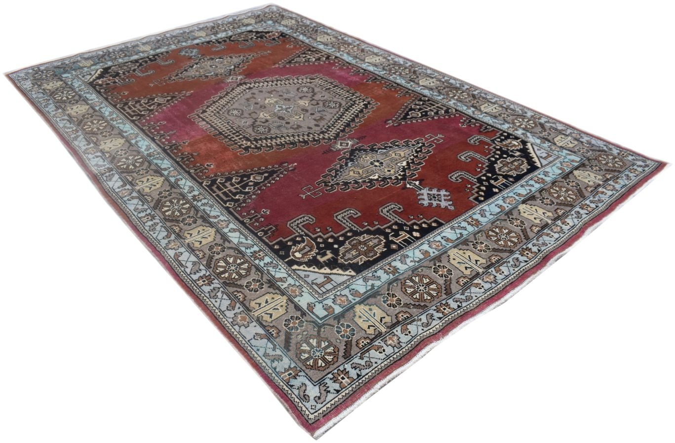 A vintage handmade Persian Wiss rug featuring a geometric medallion design in red and blue tones.