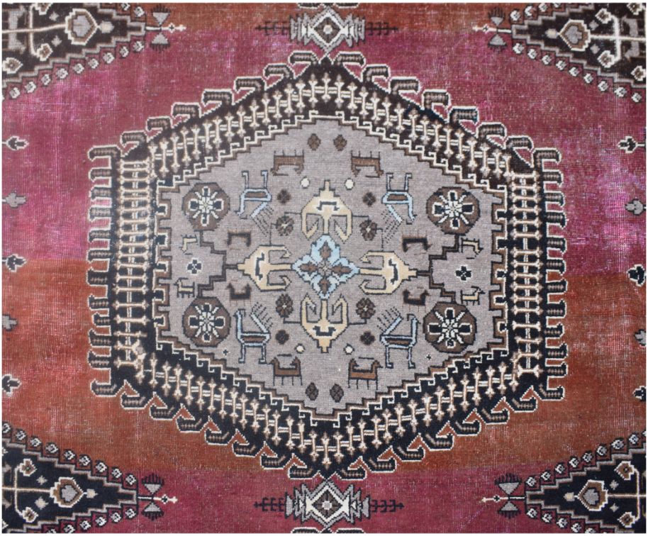 A vintage Persian Wiss rug featuring a central grey medallion with geometric motifs on a red field.
