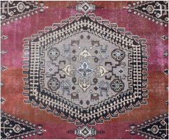 A vintage Persian Wiss rug featuring a central grey medallion with geometric motifs on a red field.