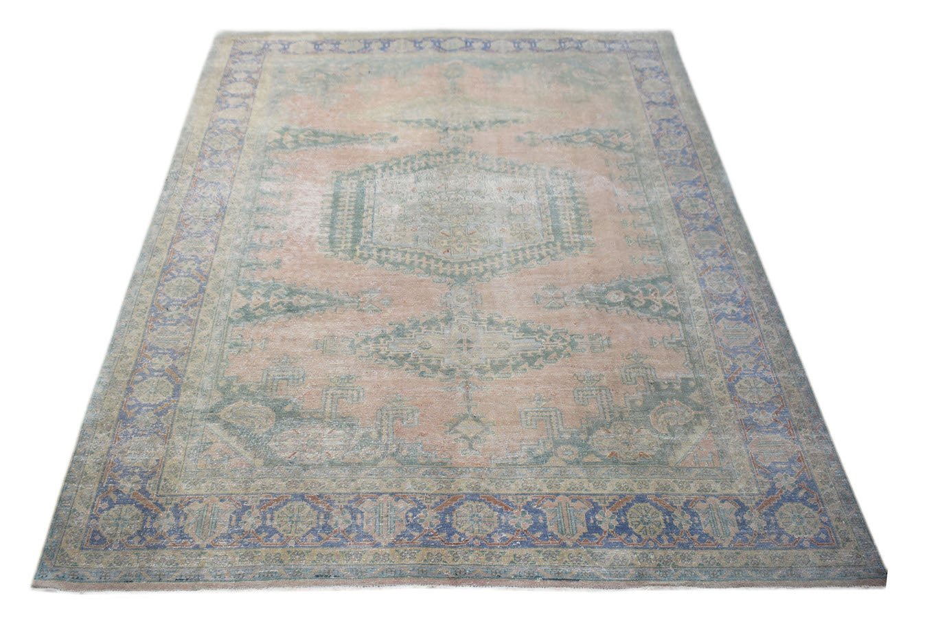 A vintage Persian Wiss rug featuring a central medallion and floral motifs in muted tones.