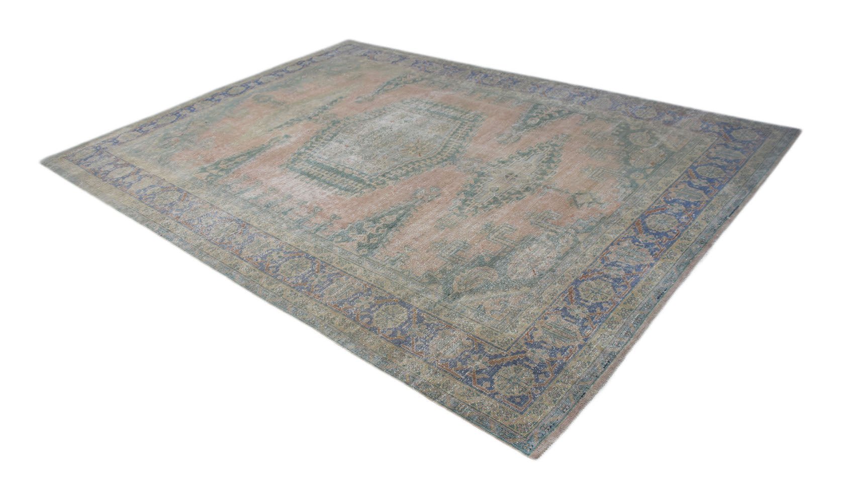 A vintage Persian rug featuring a central medallion and floral patterns in muted pink and blue.