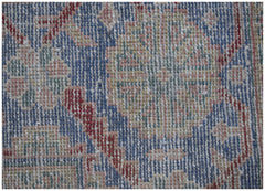 A close-up view of a vintage Persian rug featuring intricate floral patterns in blue and red.