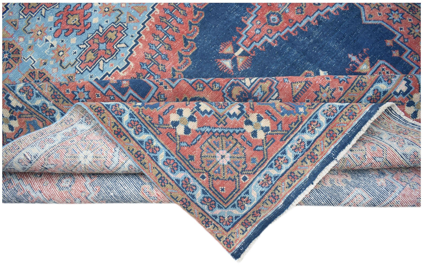 A vintage Persian Wiss rug featuring intricate geometric patterns in shades of blue and red.