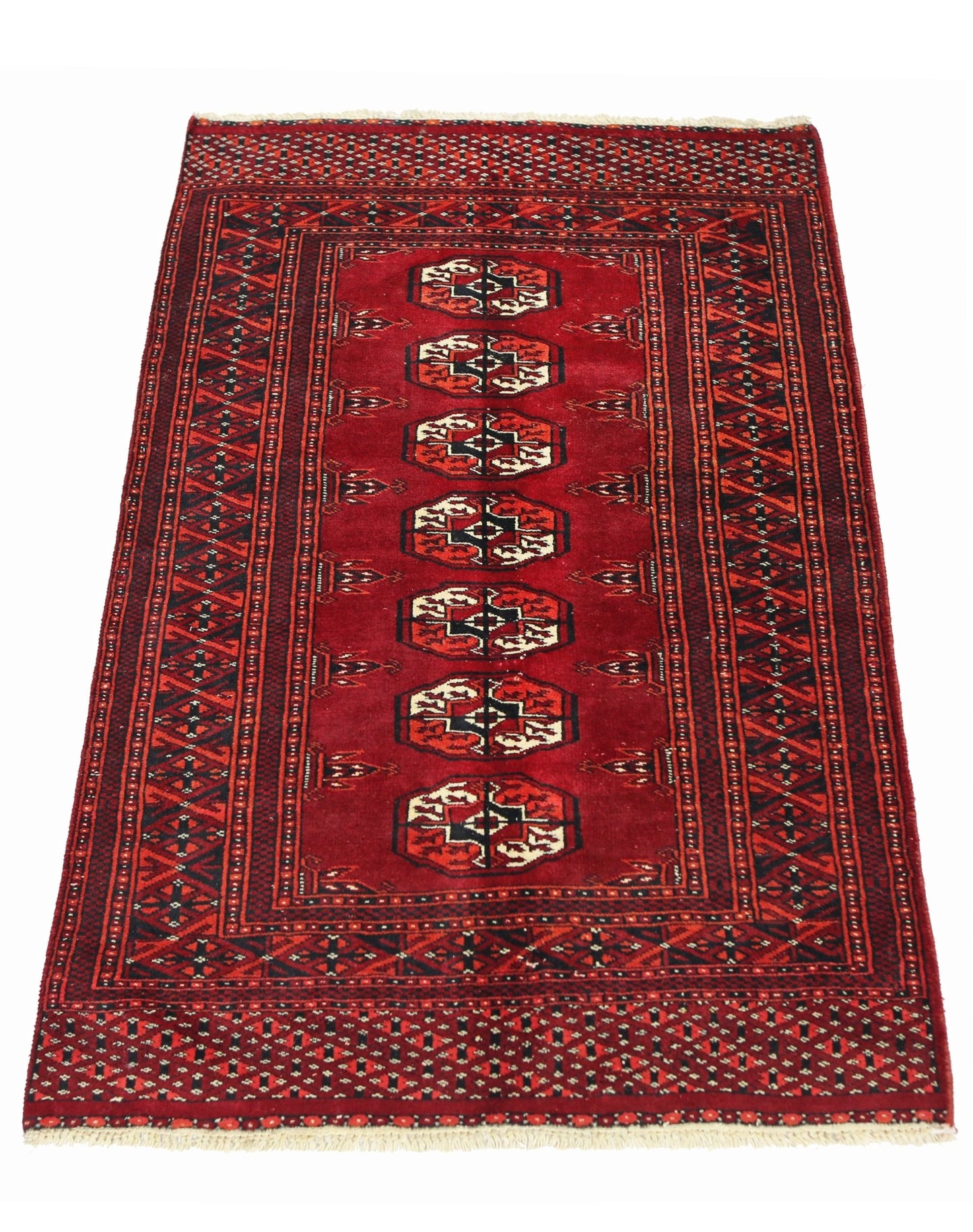 A vintage Pakistani Princess Bokhara rug featuring a deep red field with repeating geometric motifs.