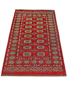 A vintage Pakistani Princess Bokhara rug featuring a repeating geometric pattern on a red field.