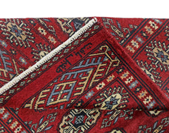 A vintage Pakistani Princess Bokhara rug featuring a geometric pattern in rich red and blue tones.