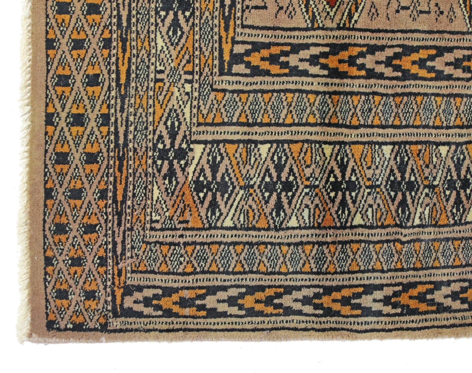 A vintage Pakistani Princess Bokhara rug featuring intricate geometric patterns in orange and black.