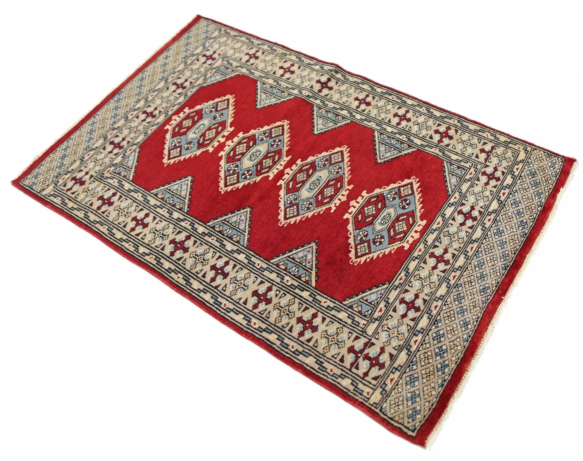 A vintage Pakistani Princess Bokhara rug featuring a red field with repeating geometric motifs.