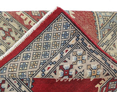 A vintage Pakistani Princess Bokhara rug with a red field and intricate geometric patterns.