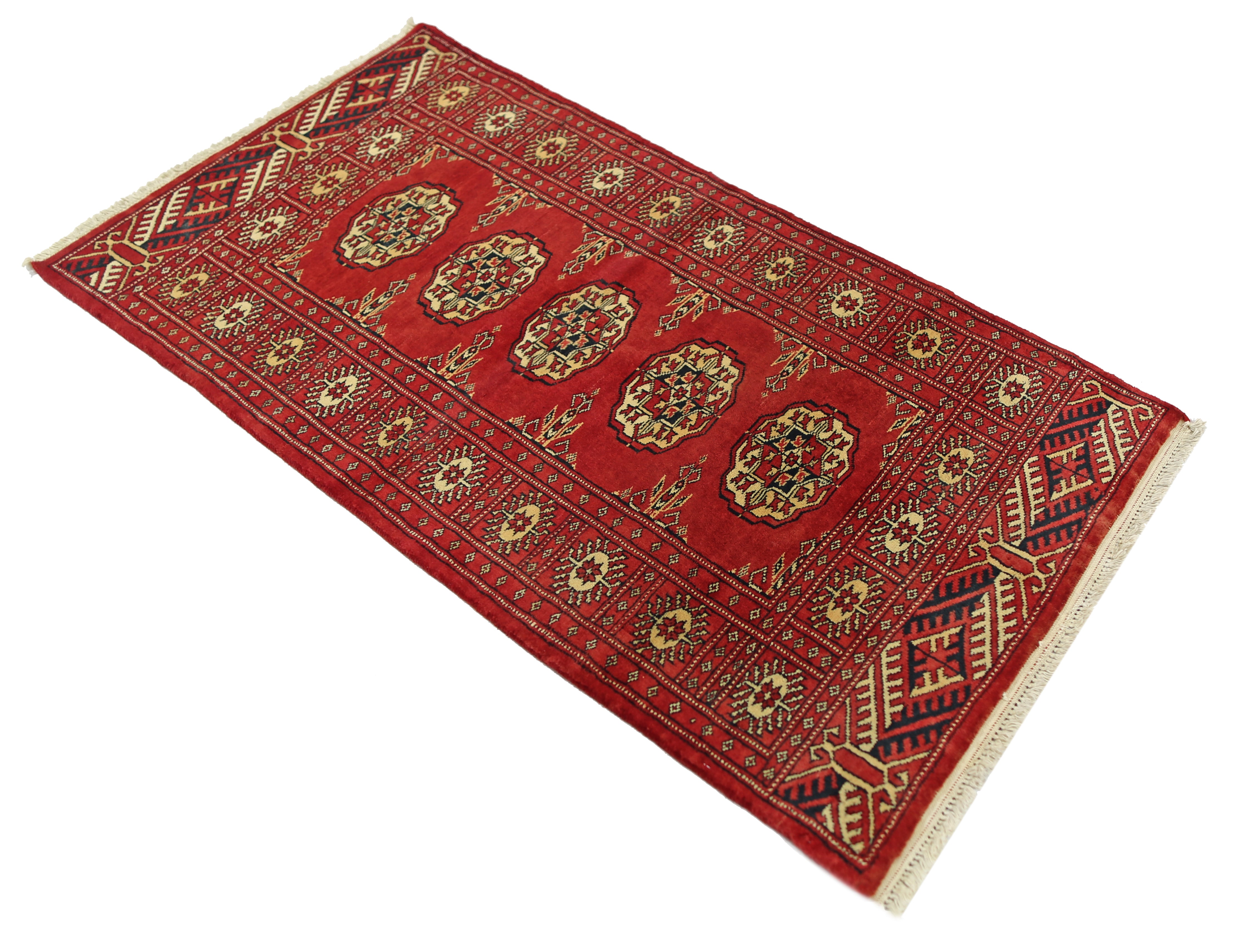 A vintage Pakistani Princess Bokhara rug featuring a repeating geometric pattern in rich red.