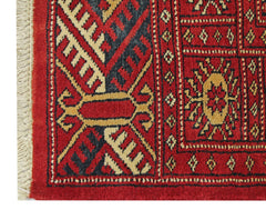 A vintage Pakistani Princess Bokhara rug featuring a geometric pattern in red, black, and tan.