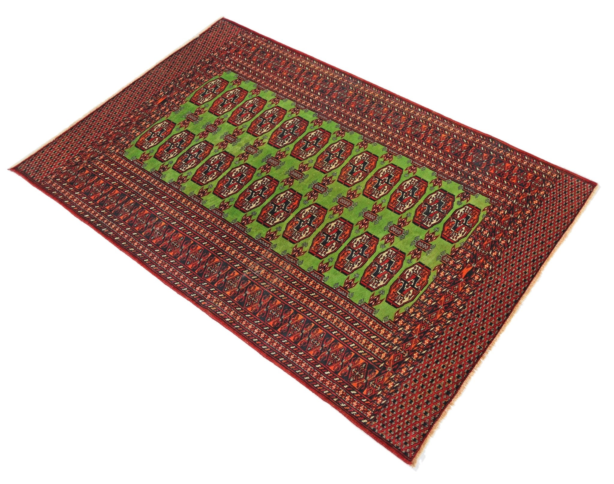 A vintage Pakistani Princess Bokhara rug featuring a vibrant green field with repeating red motifs.
