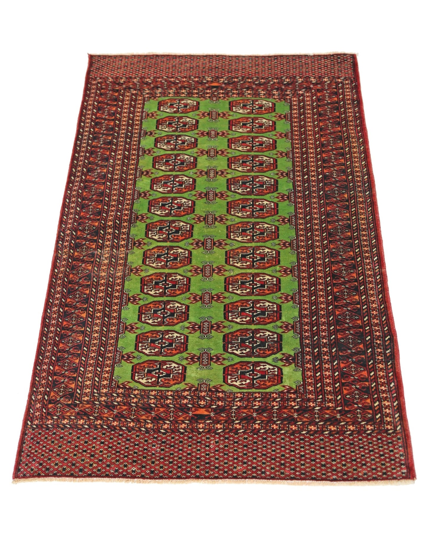 A vintage Pakistani Princess Bokhara rug featuring a green field with repeating geometric motifs.