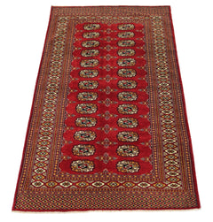 A vintage Pakistani Princess Bokhara rug featuring a red field with repeating geometric motifs.