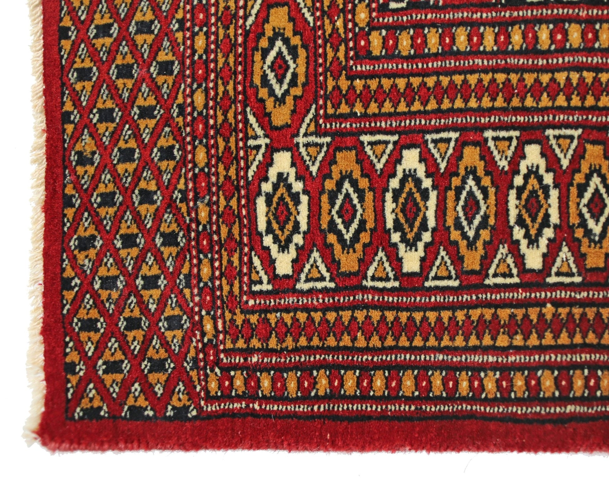 A vintage Pakistani Princess Bokhara rug featuring a geometric diamond pattern in red and gold.