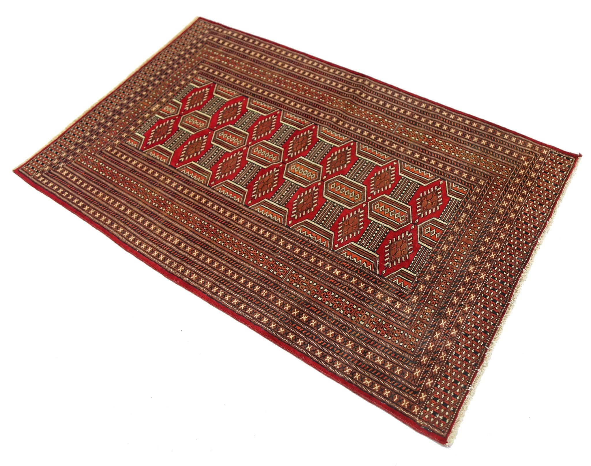 A vintage Pakistani Princess Bokhara rug featuring a geometric red and brown pattern.