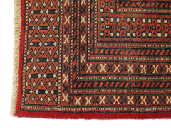 A vintage Pakistani Princess Bokhara rug featuring a geometric pattern in red and black wool.