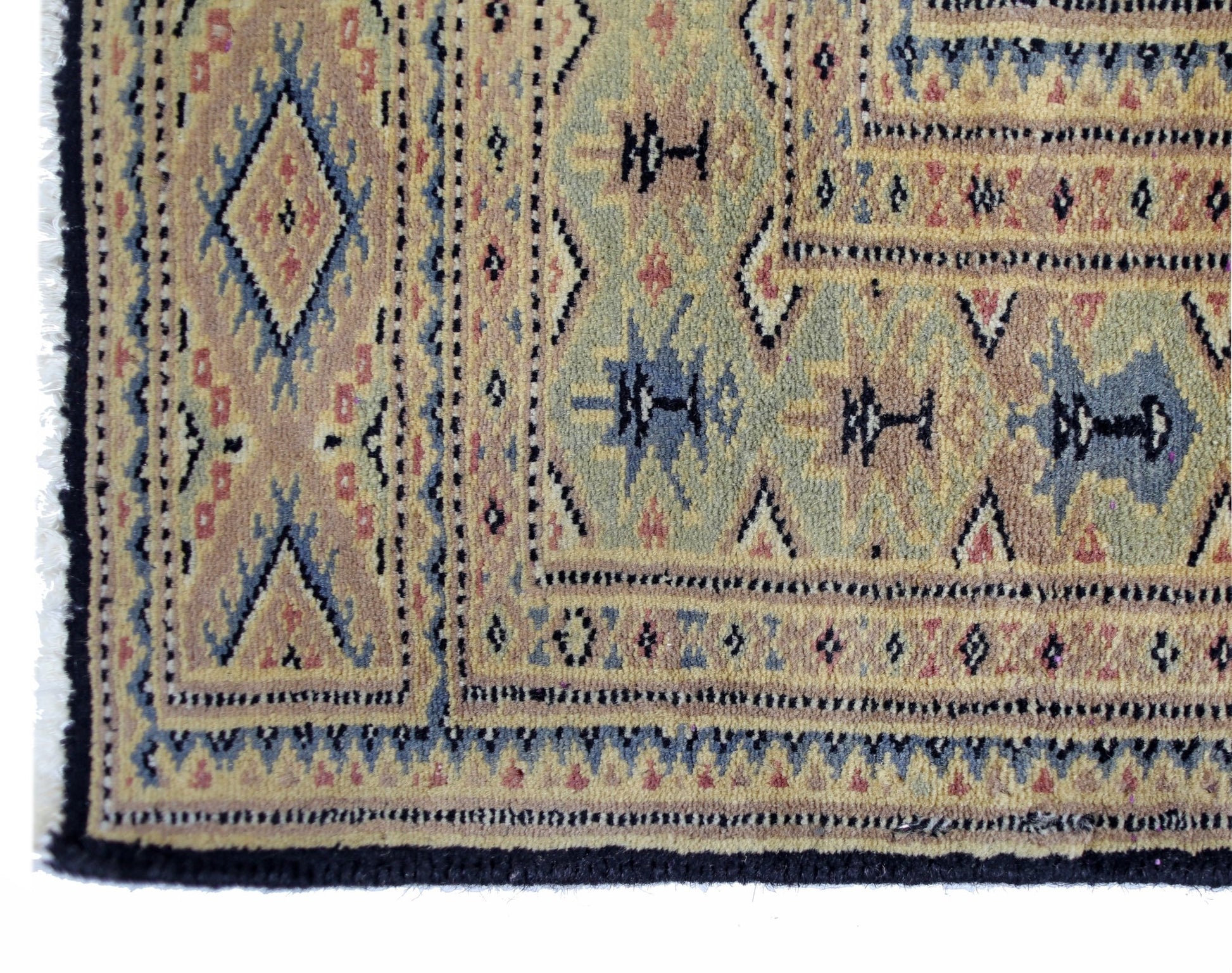 A vintage Pakistani Princess Bokhara rug featuring intricate geometric patterns in muted tones.