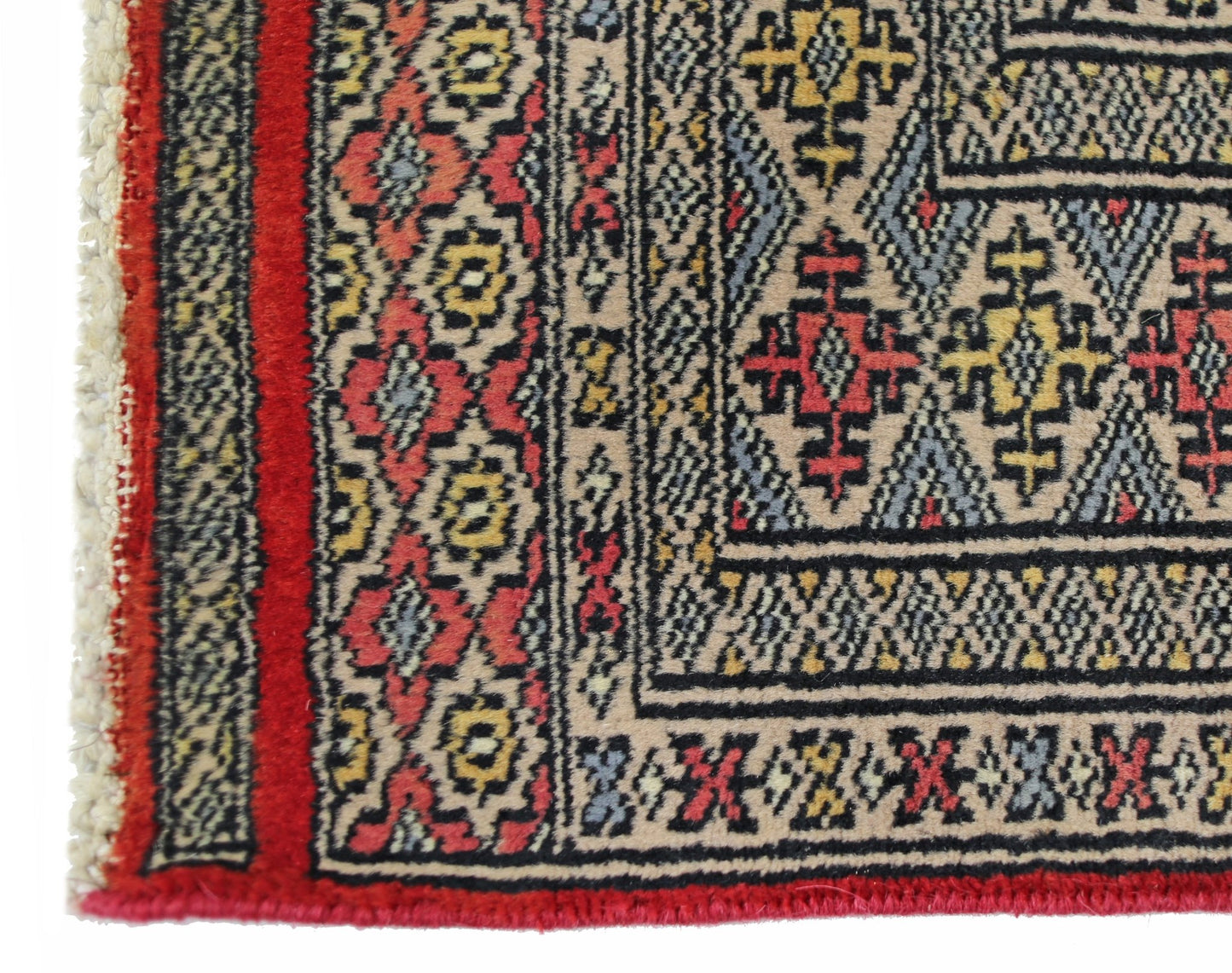 A vintage Pakistani Princess Bokhara rug featuring intricate geometric patterns in red, yellow, and blue.