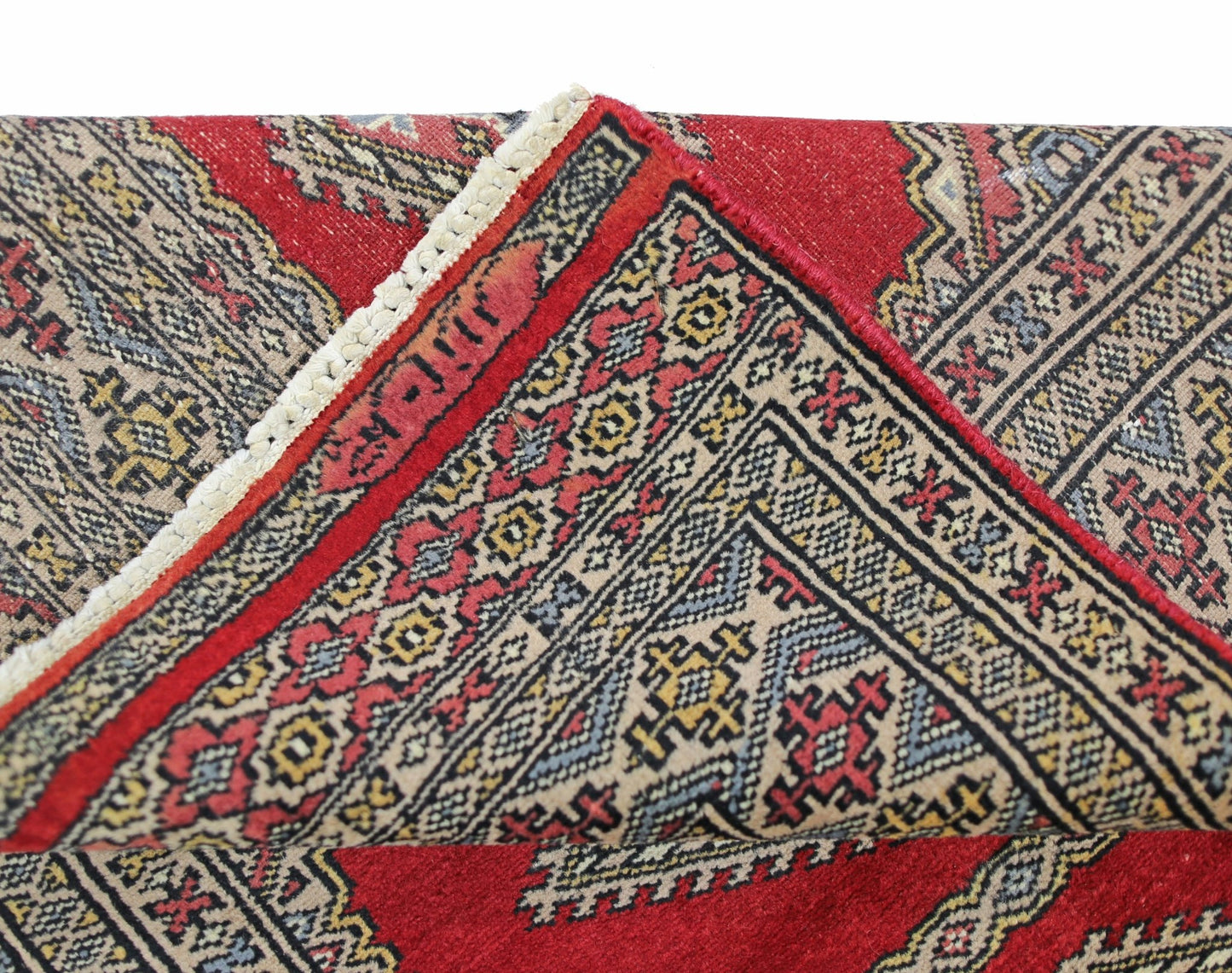A vintage Pakistani Princess Bokhara rug featuring a geometric pattern in red, cream, and blue.