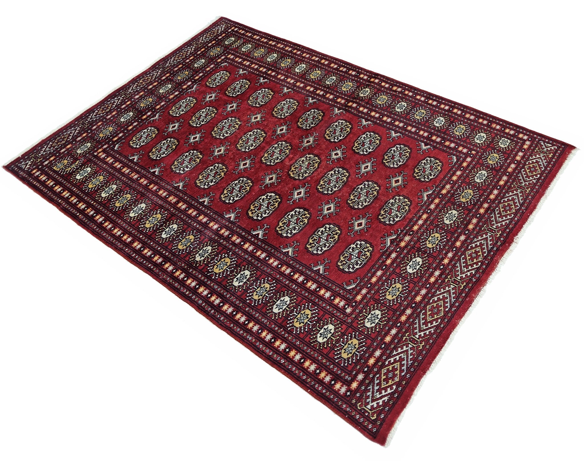 A vintage Pakistani Princess Bokhara rug featuring a repeating geometric pattern on a red field.