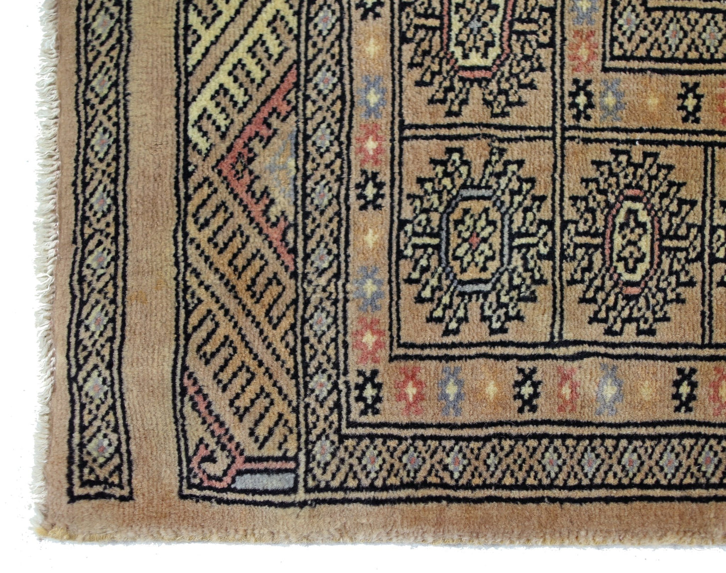 A vintage Pakistani Princess Bokhara rug featuring geometric patterns in warm, earthy tones.