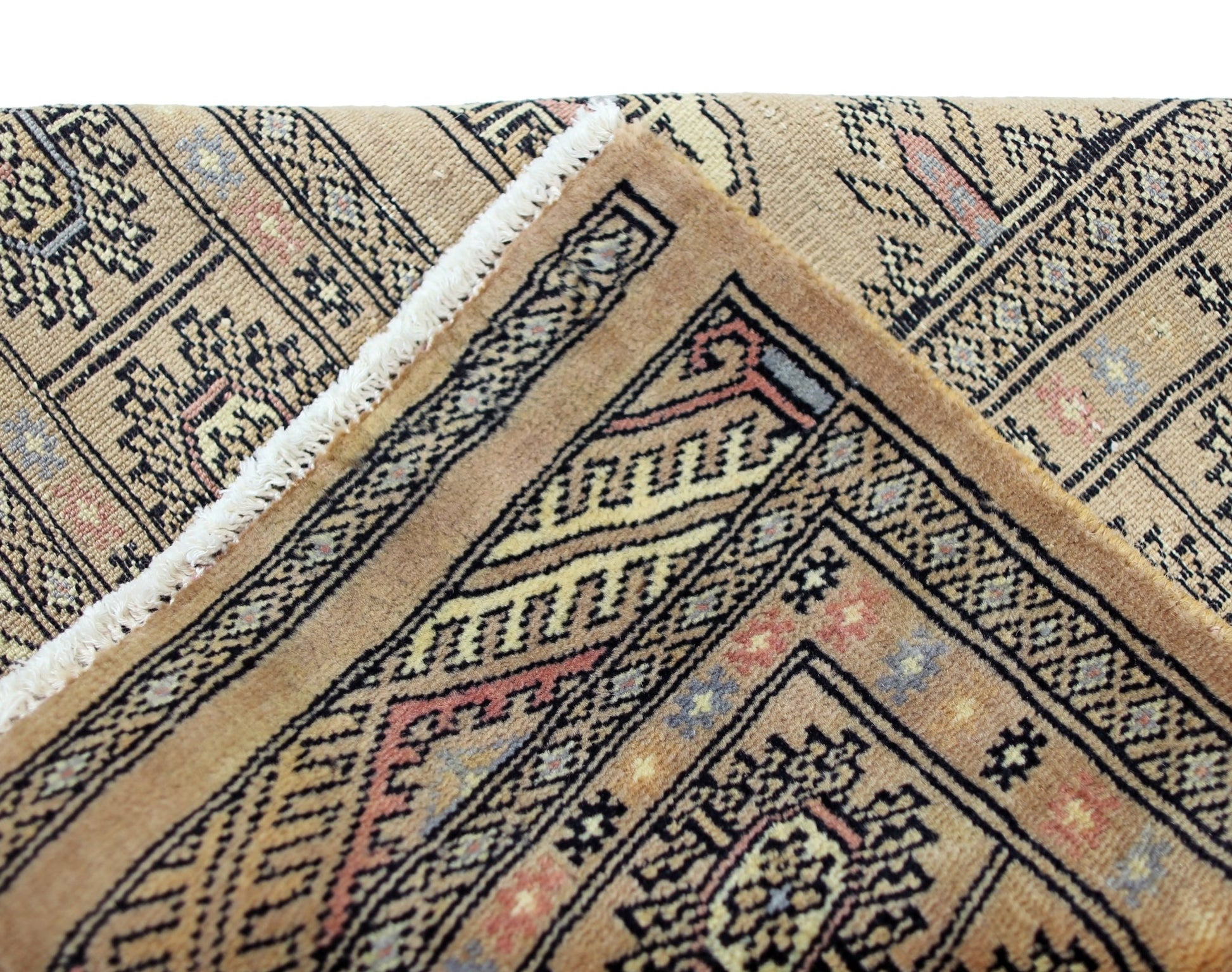 A vintage Pakistani Princess Bokhara rug featuring intricate geometric patterns in warm tones.