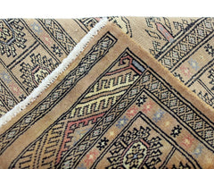 A vintage Pakistani Princess Bokhara rug featuring intricate geometric patterns in warm tones.