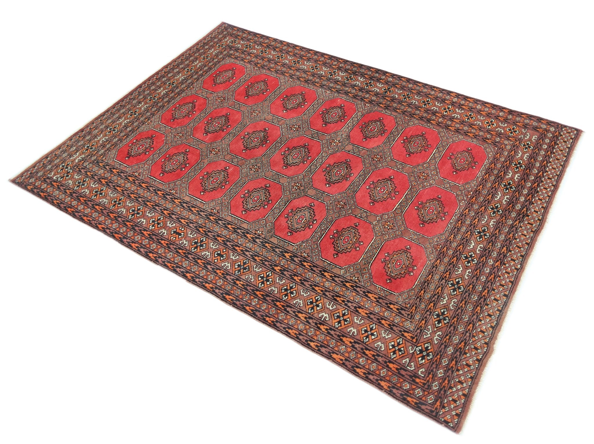 A vintage Pakistani Princess Bokhara rug featuring a repeating octagonal pattern in red and brown.