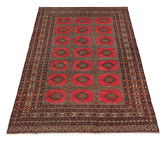 A vintage Pakistani Princess Bokhara rug featuring a repeating octagonal pattern in red and brown.