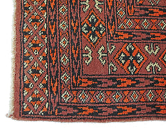 A vintage Pakistani Princess Bokhara rug featuring a geometric pattern in red, black, and cream.