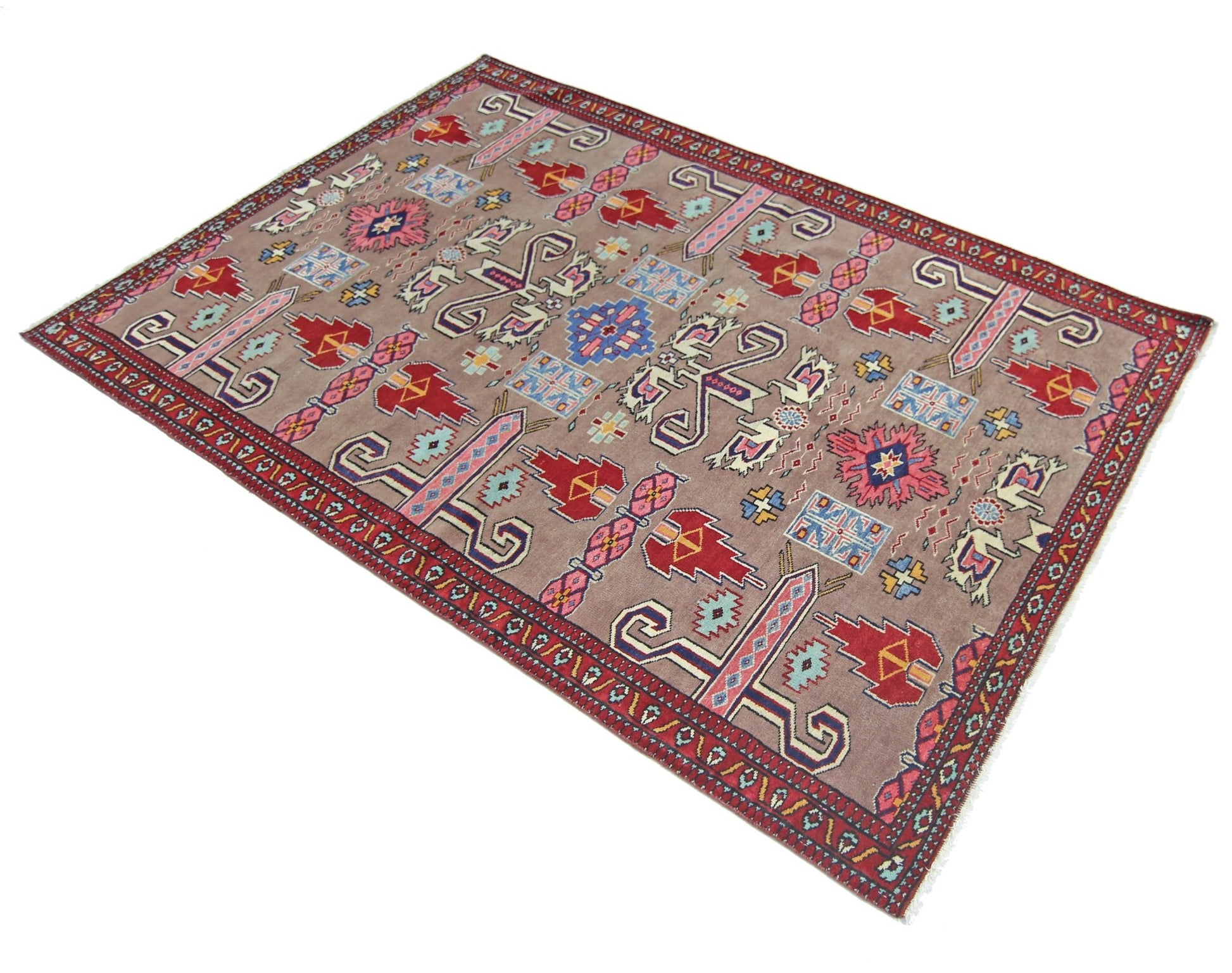 A vintage Pakistani Princess Bokhara rug featuring geometric patterns on a mauve wool background.