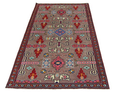 A vintage Pakistani Princess Bokhara rug featuring geometric patterns in red, blue, and pink.
