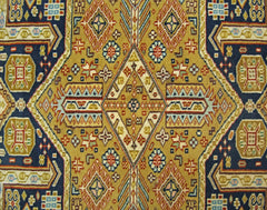 A vintage Pakistani Princess Bokhara rug featuring a geometric diamond pattern in gold and blue.