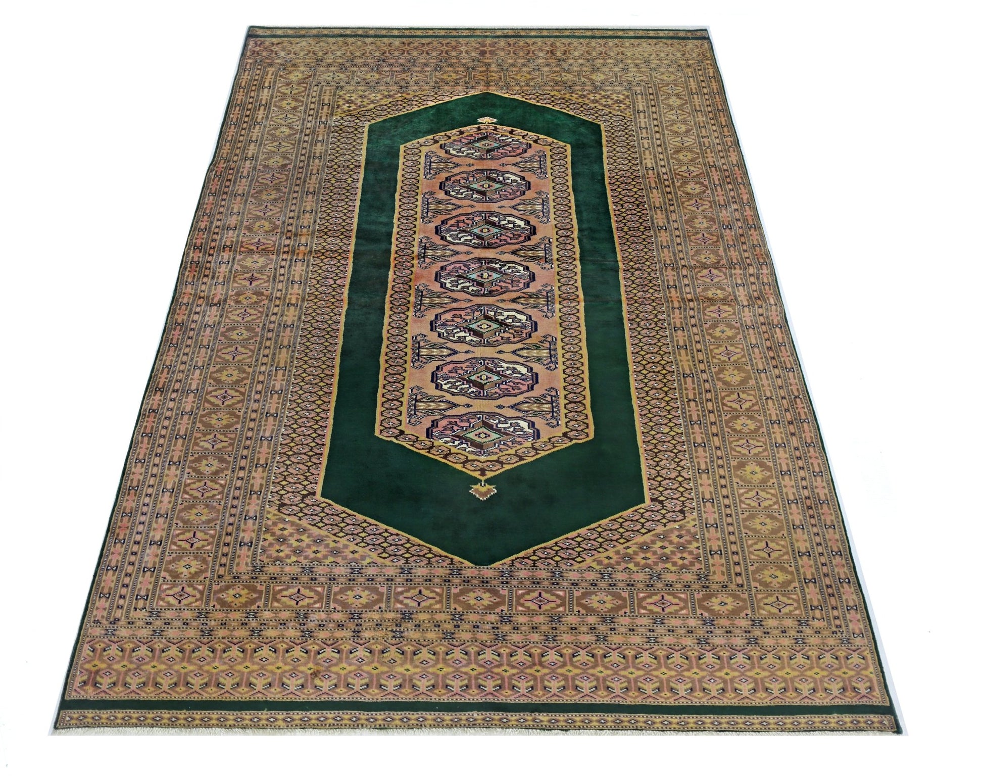 A vintage Pakistani Princess Bokhara rug featuring a deep green field with repeating geometric motifs.