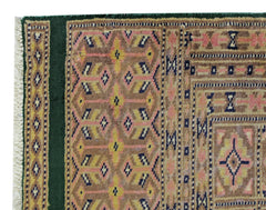A vintage Pakistani Princess Bokhara rug featuring a geometric pattern in pink, yellow, and blue.