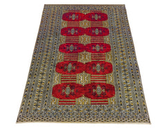 A vintage Pakistani Princess Bokhara rug featuring a deep red field with repeating geometric motifs.