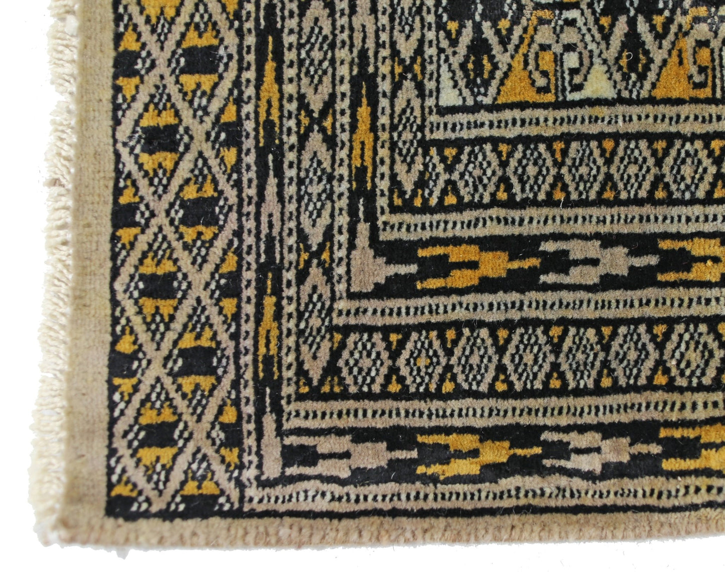 A vintage Pakistani Princess Bokhara rug featuring a geometric diamond pattern in black and gold.
