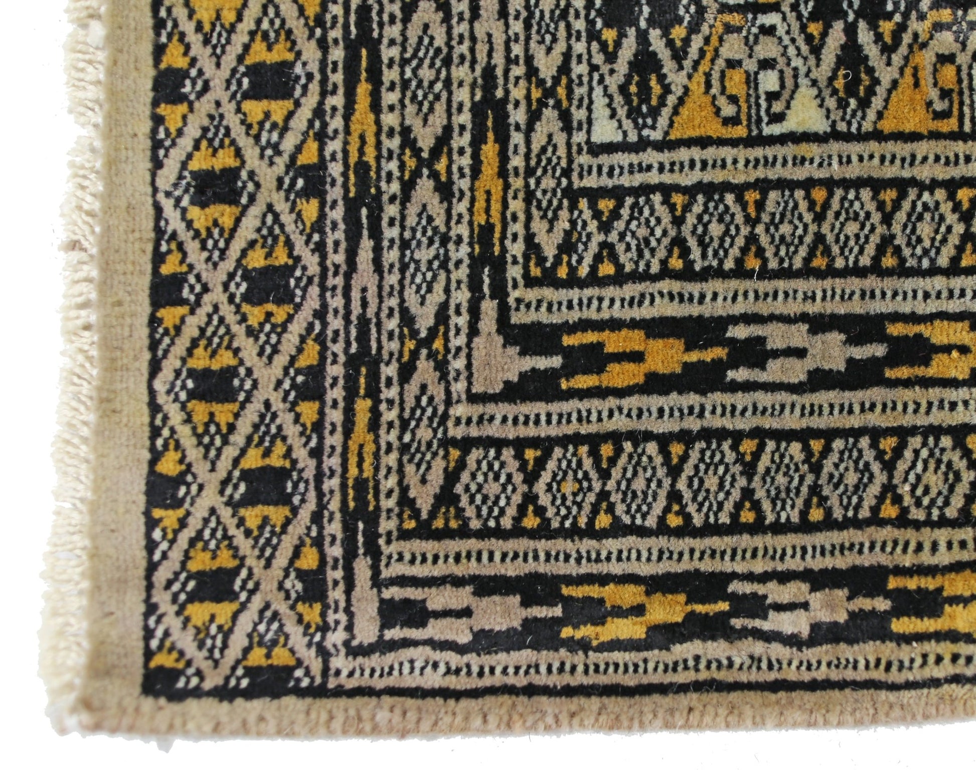 A vintage Pakistani Princess Bokhara rug featuring a geometric diamond pattern in black and gold.
