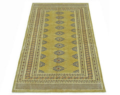 A vintage Pakistani Princess Bokhara rug featuring a golden field with repeating geometric motifs.