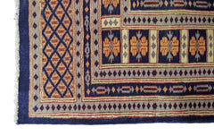 A vintage Pakistani Princess Bokhara rug featuring a geometric diamond pattern and floral motifs.