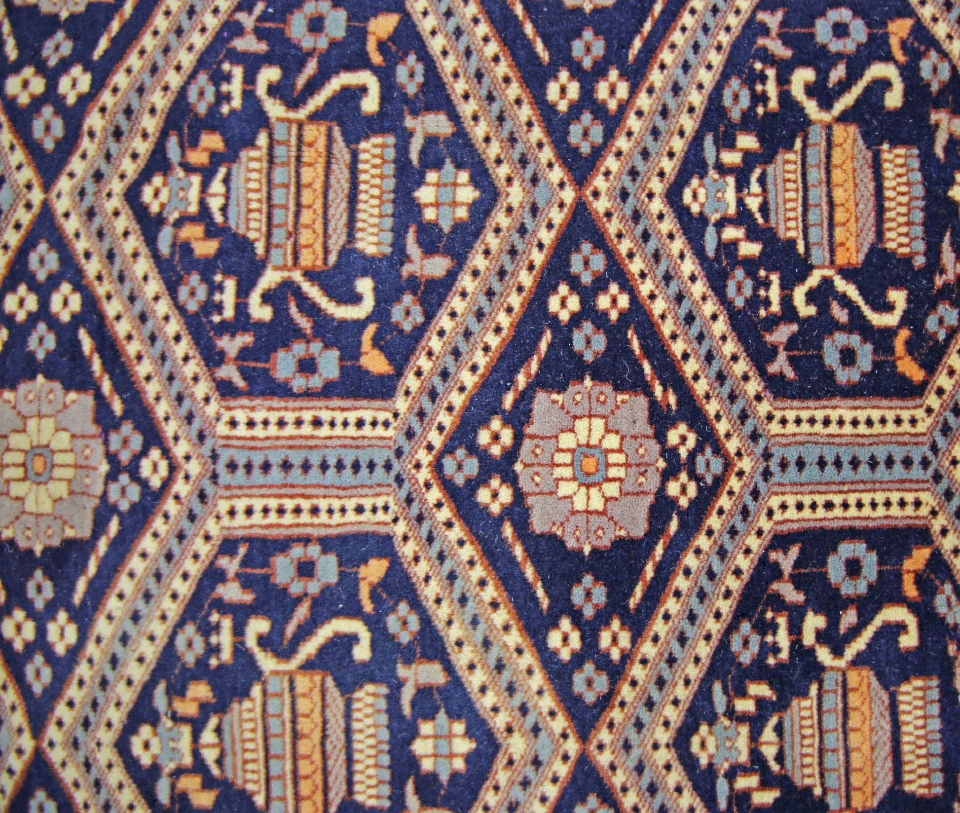 Vintage Pakistani Princess Bokhara rug featuring a repeating diamond pattern in blue and gold.