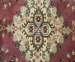 A vintage Pakistani Princess Bokhara rug featuring a central geometric medallion on a red field.