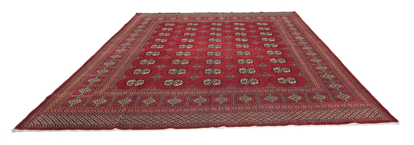 A vintage Pakistani Princess Bokhara rug featuring a deep red field with repeating geometric motifs.