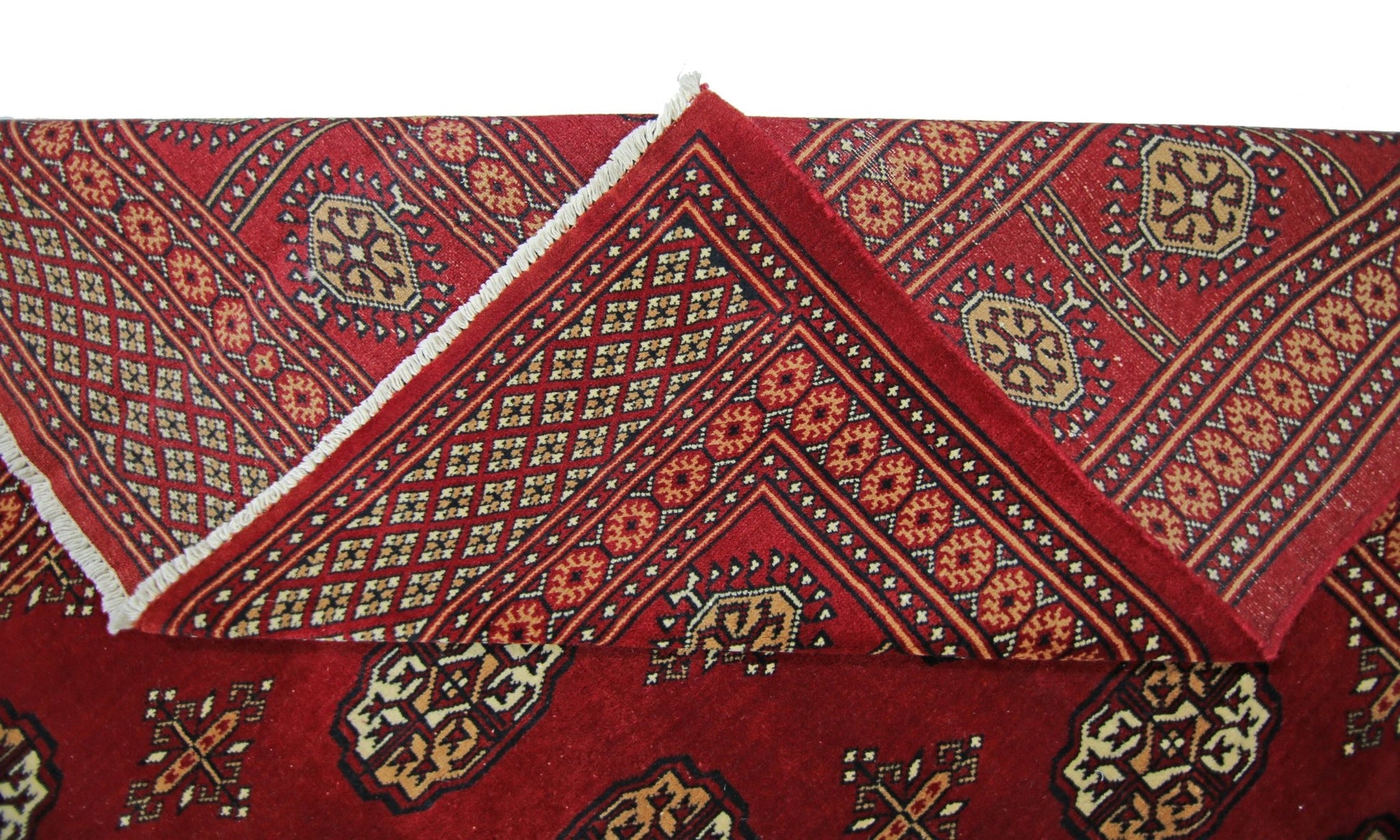 A vintage Pakistani Princess Bokhara rug featuring a deep red field with traditional geometric motifs.