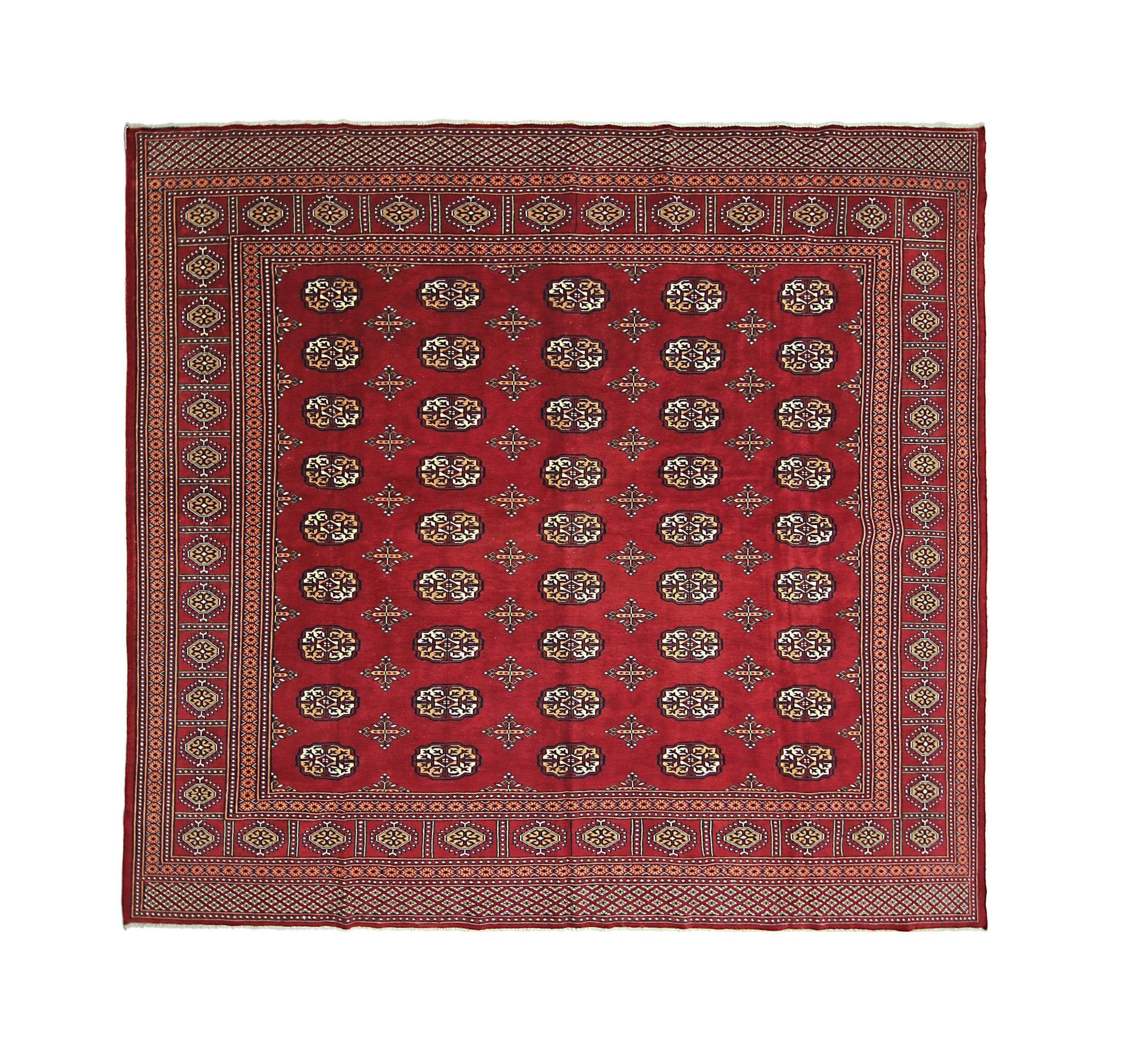 A square vintage Pakistani Princess Bokhara rug featuring a repeating geometric pattern in red.