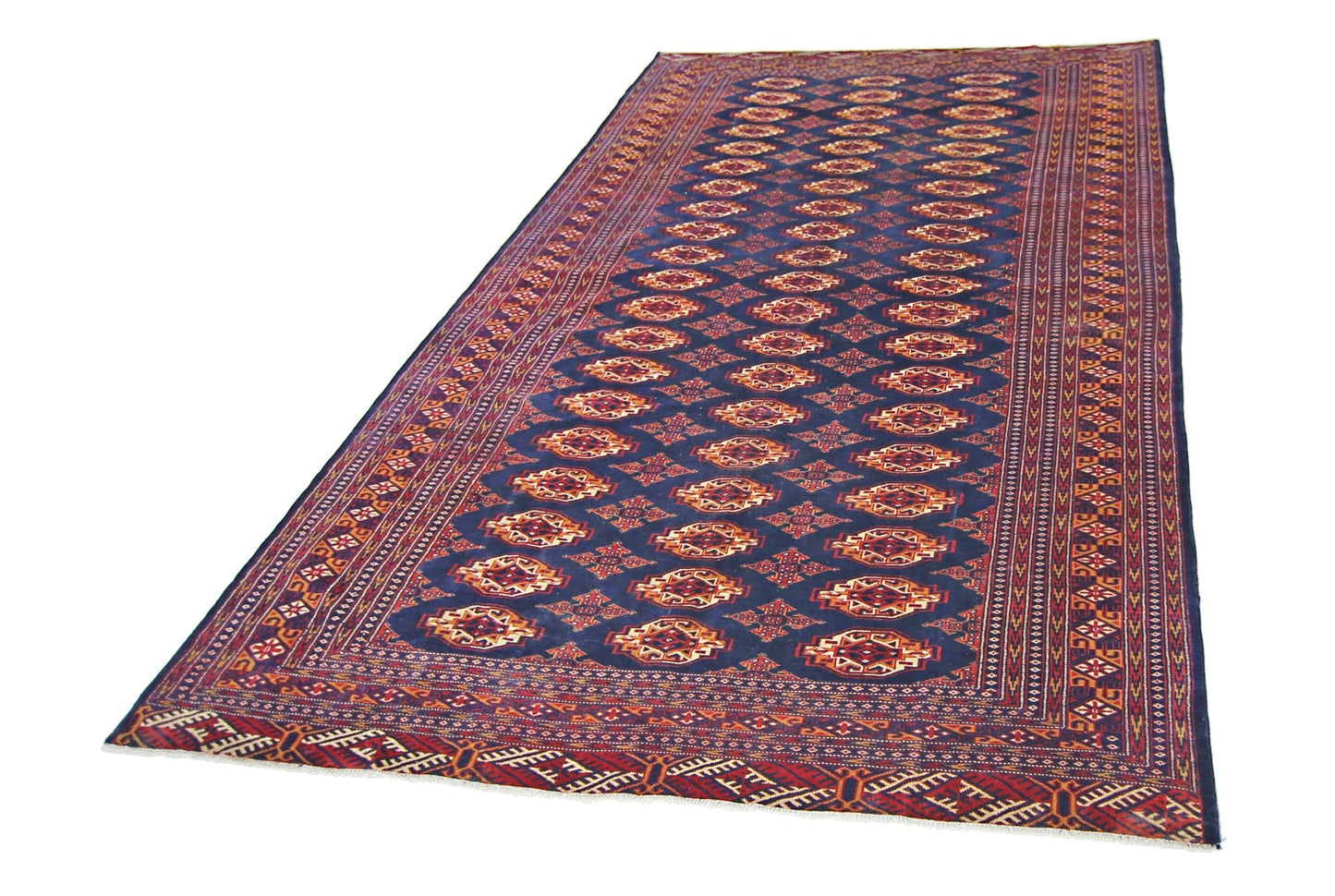 A vintage Pakistani Princess Bokhara rug featuring a repeating geometric pattern on a blue field.