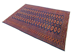 A vintage Pakistani Princess Bokhara rug featuring a repeating geometric pattern in deep blue.