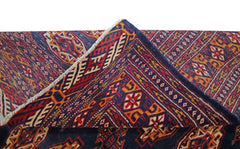 A vintage Pakistani Princess Bokhara rug featuring a deep blue field with intricate red patterns.
